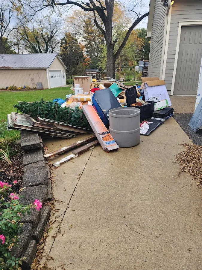 Dumpster being loaded with debris for Commercial Dumpster Rental in Sunapee